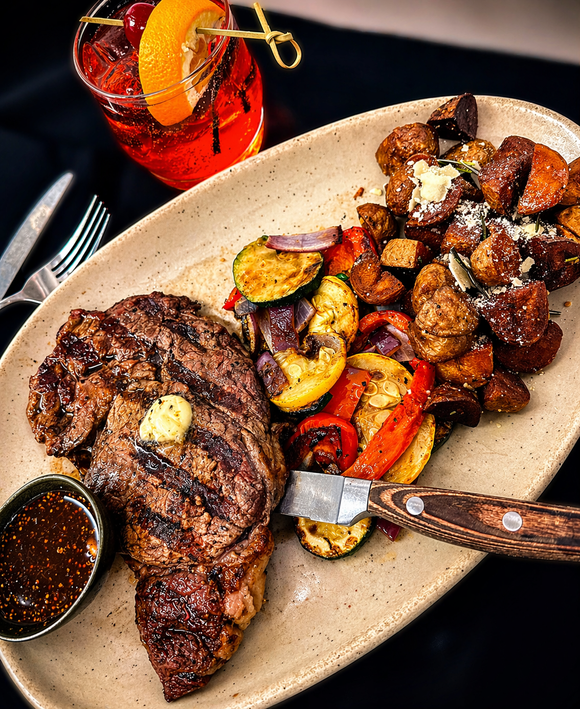 Trainwreck Grill ribeye steak with roasted potatoes and vegetables in Coldwater Michigan
